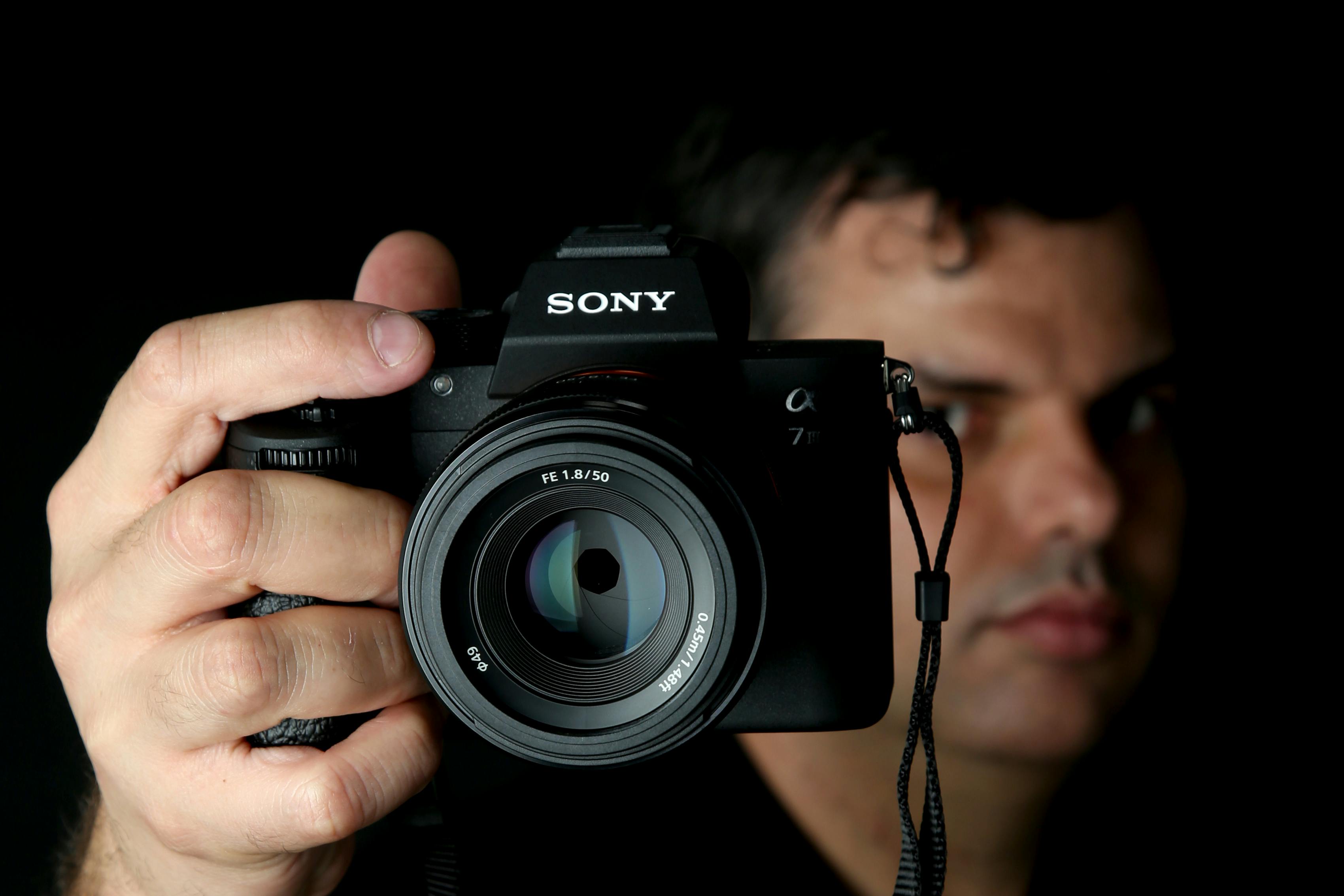 someone taking a picture with a sony camera